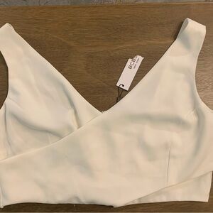 BCBG sleeveless cross cross top features a distinctive wrap-style v-neckline NWT